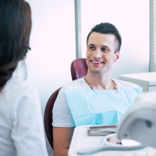 Dental patient talking to dental team member