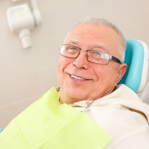 Senior man smiling in dental chair