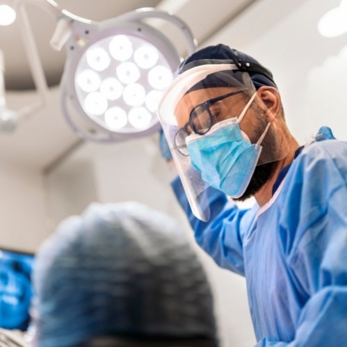 Dentist wearing personal protective equipment while treating a patient