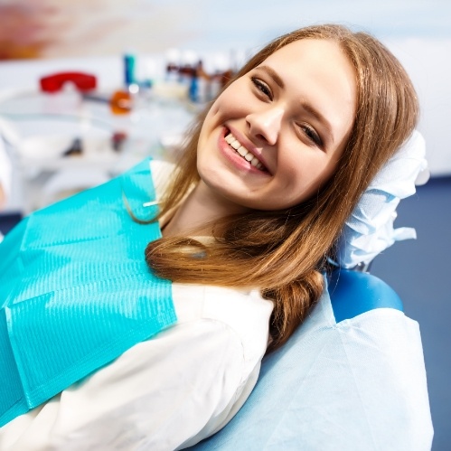 Young woman grinning in dental chair