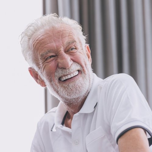 Smiling older man in white polo shirt