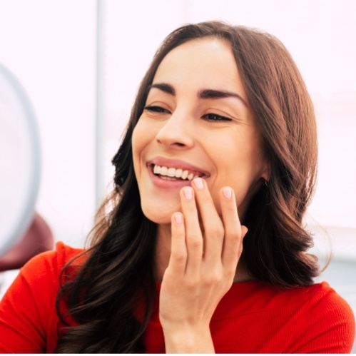 Woman looking at her smile in mirror