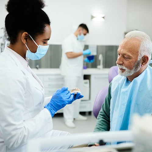 Full dentures on tray next to dental mirrors