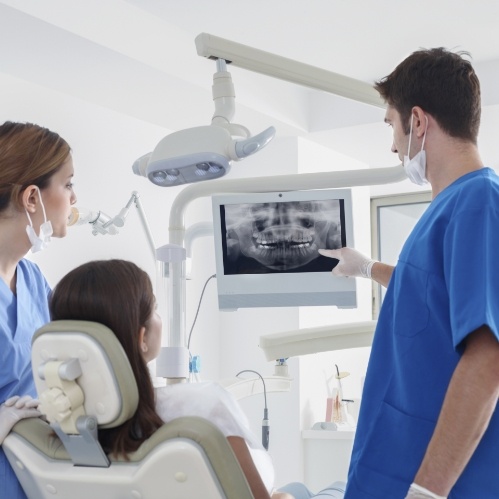 Dentist showing a patient digital dental images of their teeth
