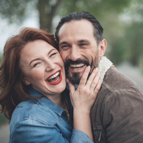 Woman hugging man and smiling after gum contouring in Carrollton