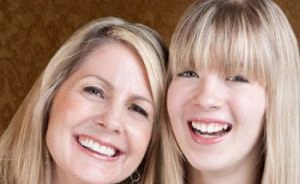 Mother and daughter smiling together