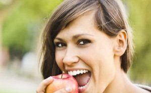 Brunette woman grinning outdoors