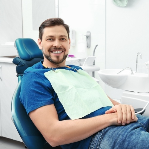 Man sitting in dental chair after receiving laser cavity detection in Carrollton