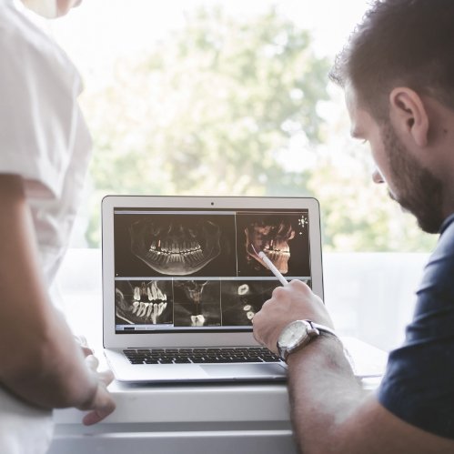 Dentist showing a patient digital x rays of their teeth