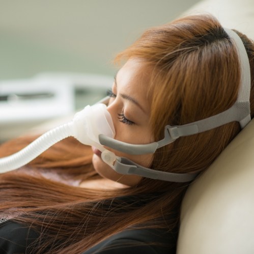 Sleeping woman wearing a C P A P mask