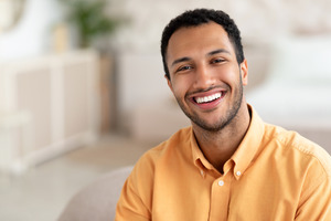 Man in button-up shirt smiling
